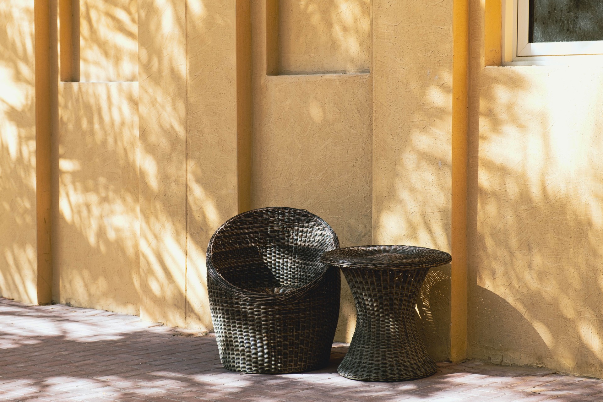 Wicker Chair and Table in Sunlit Outdoor Setting